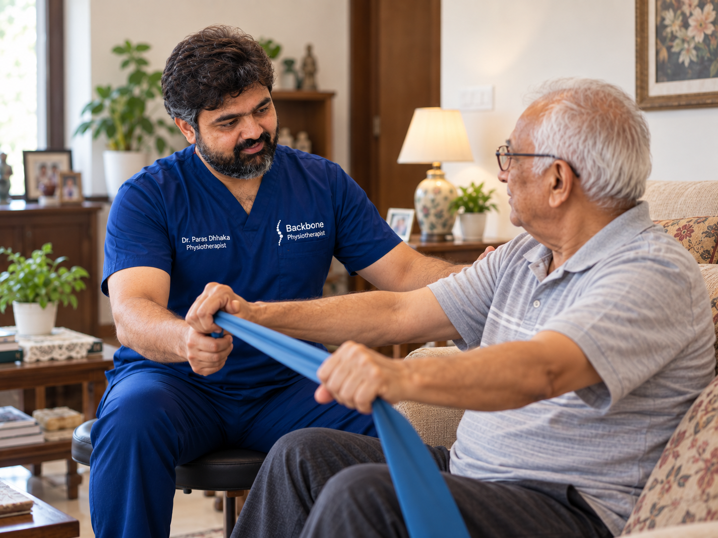 Physiotherapist guiding an older patient through a resistance-band exercise at home